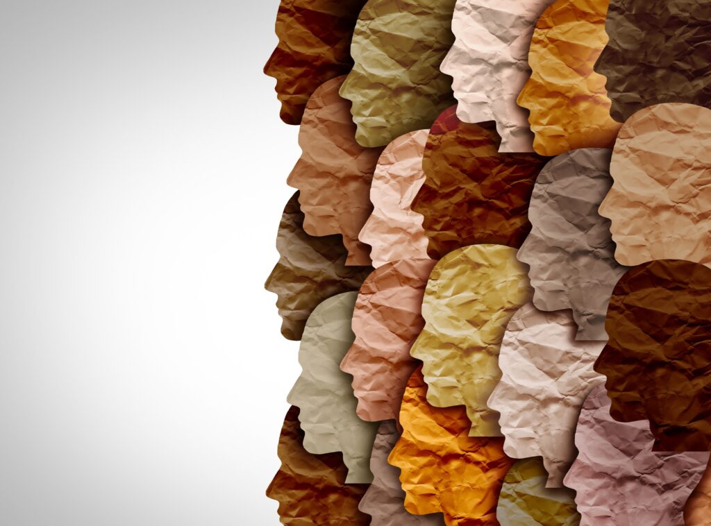 Paper design showing profile shot of heads of people in different skin colours.