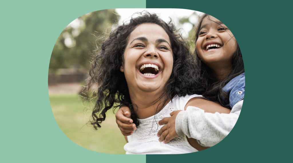 Woman at the park smiling with her child