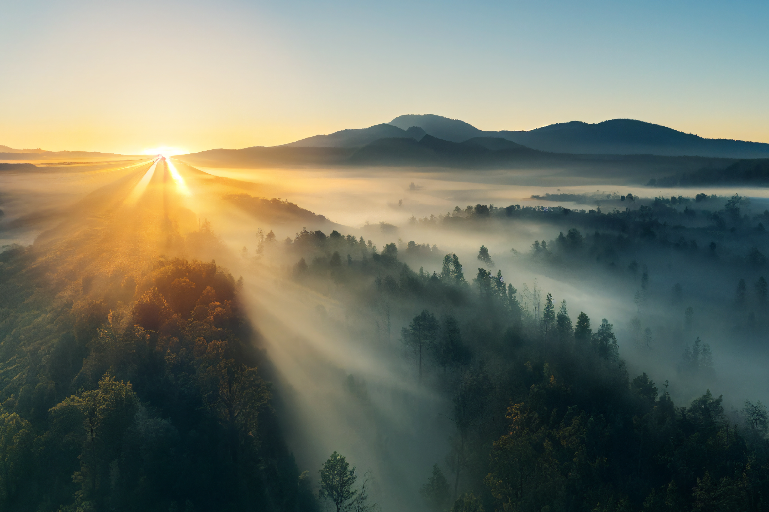 photo of sun rising over the mountains