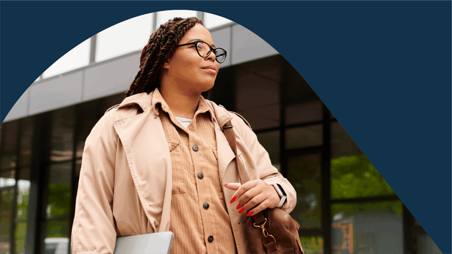 Woman with laptop and bag on campus