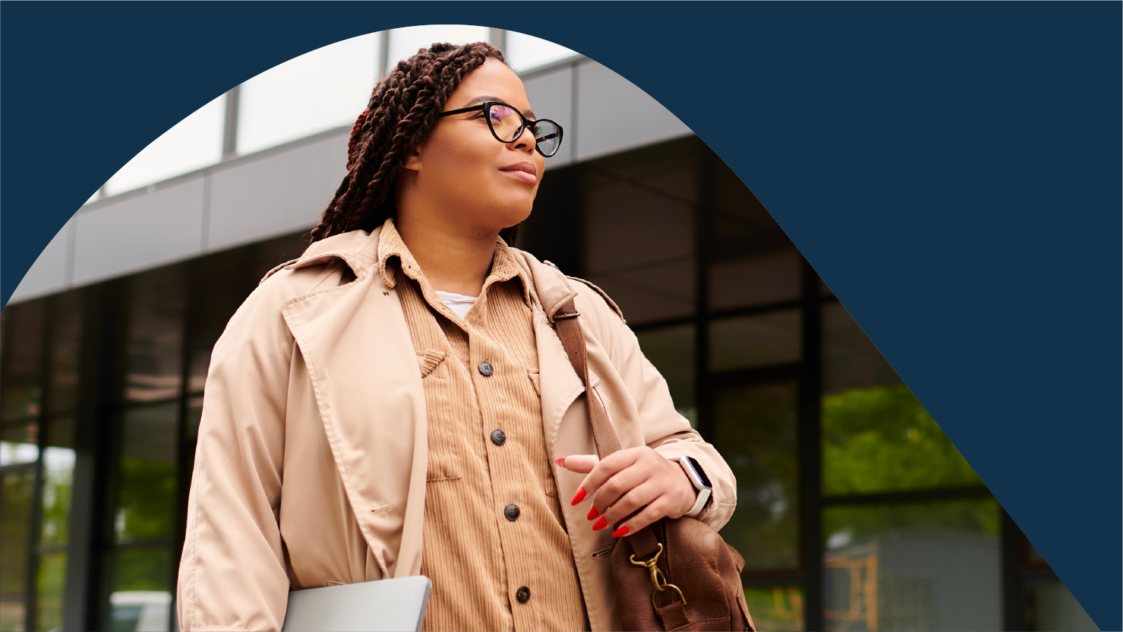 Woman with laptop and bag on campus