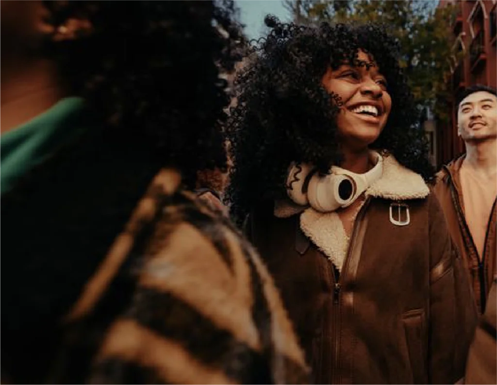 A group of young adults walking through the city at golden hour